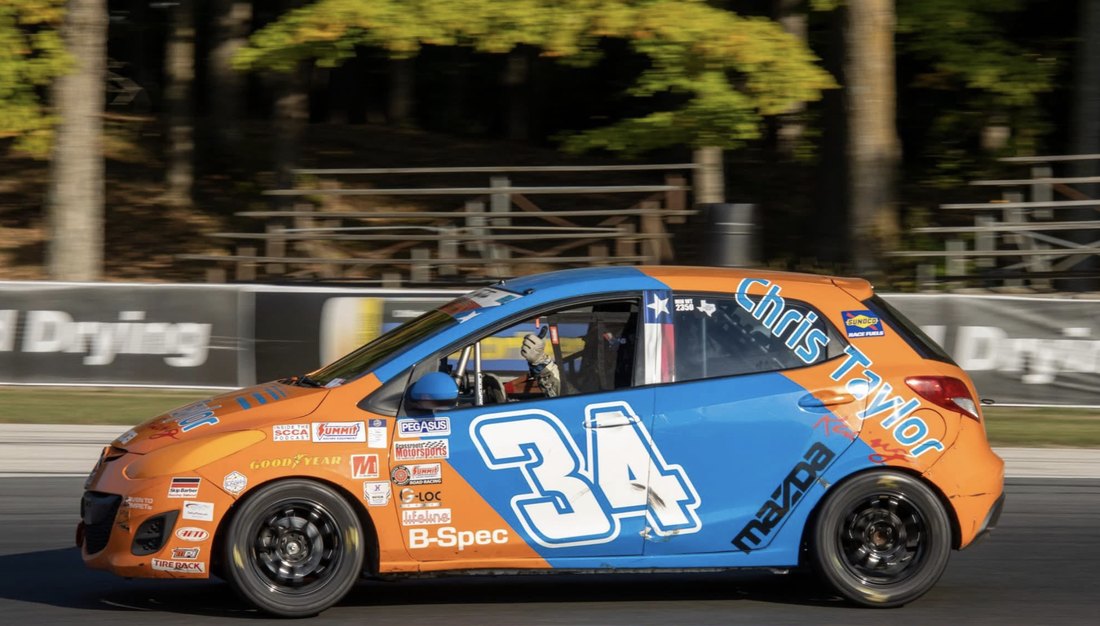 Chris Taylor's #34 B-Spec Mazda2 on track